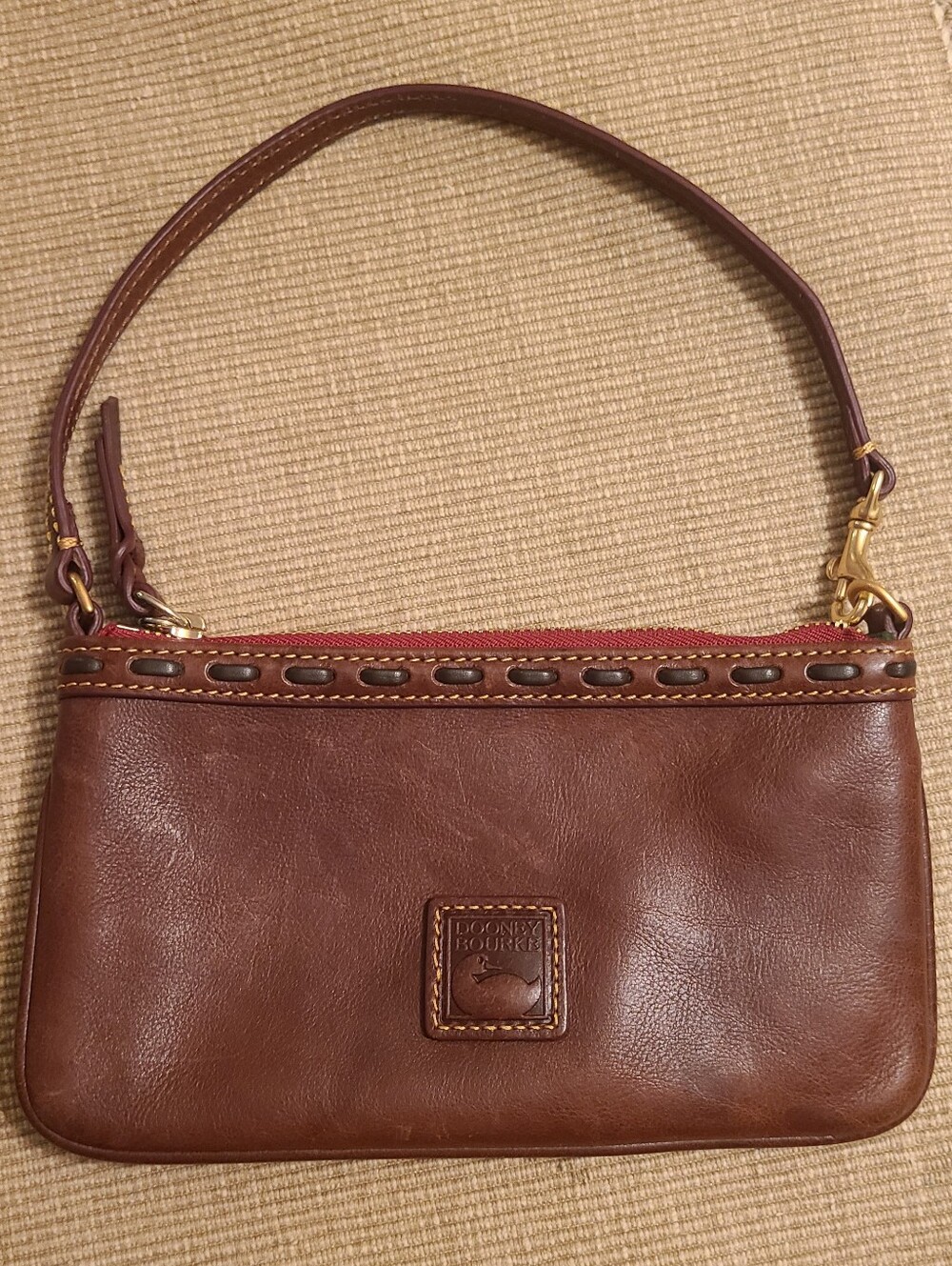 Dooney & Bourke Brown Leather Wristlet with Red Zip Accent